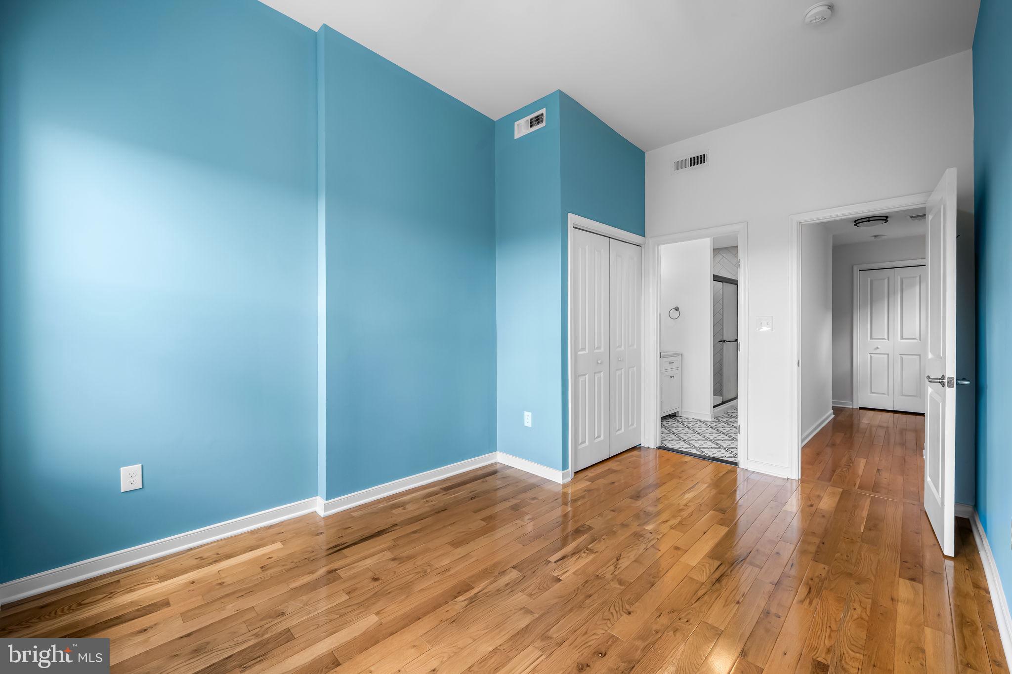 3716 Gough Street Baltimore, MD 21224 - Photo 18 of 33 a view of a big room with wooden floor and windows