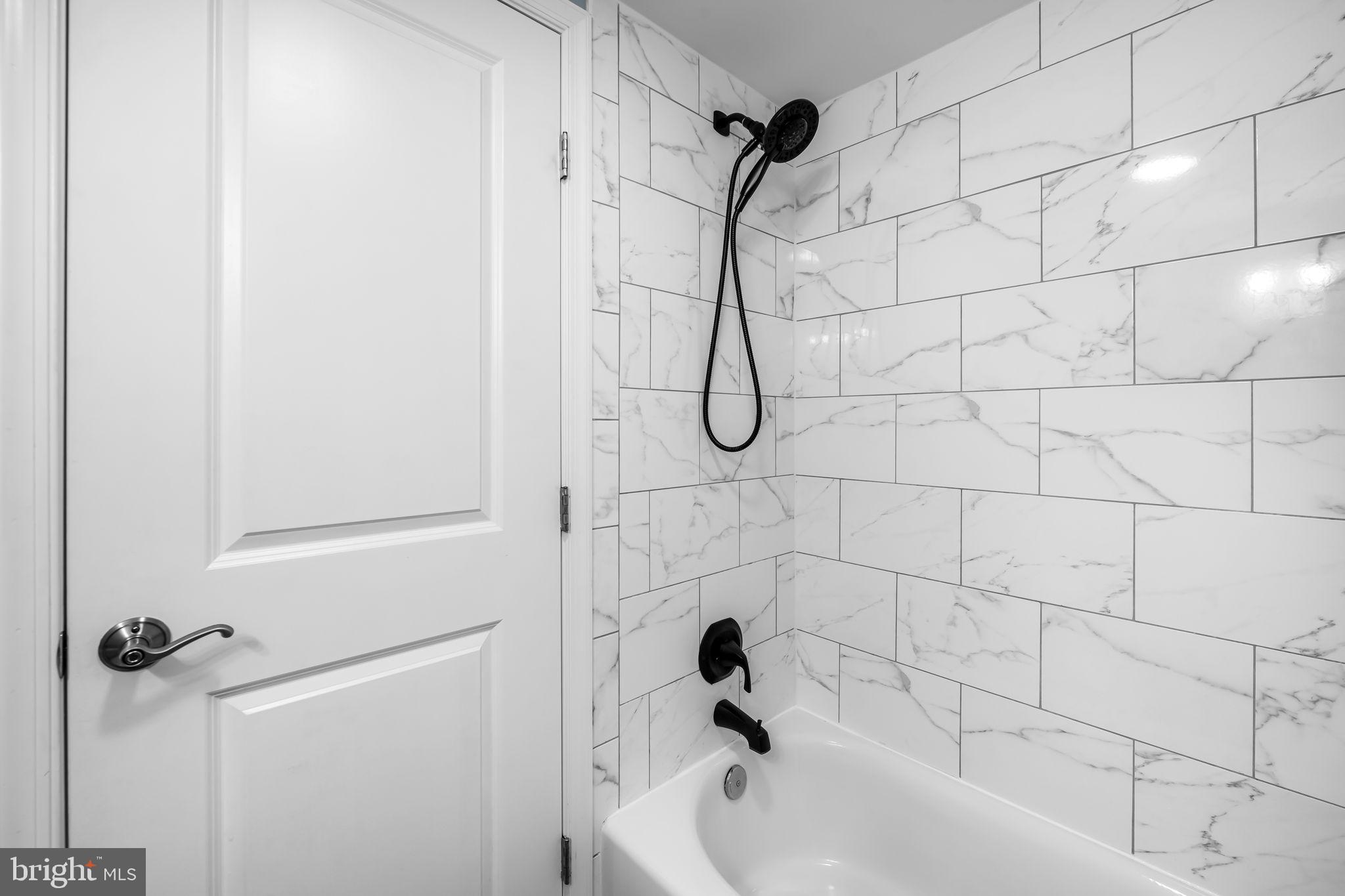 3716 Gough Street Baltimore, MD 21224 - Photo 23 of 33 a bathroom with a shower and a bathtub