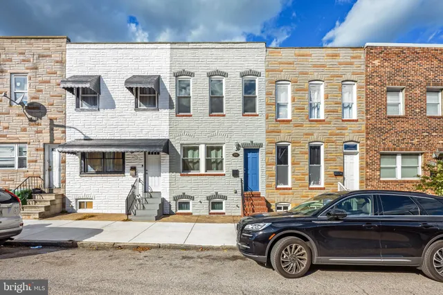 a front view of a house with parking space