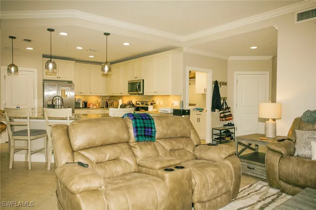 a living room with furniture and kitchen view