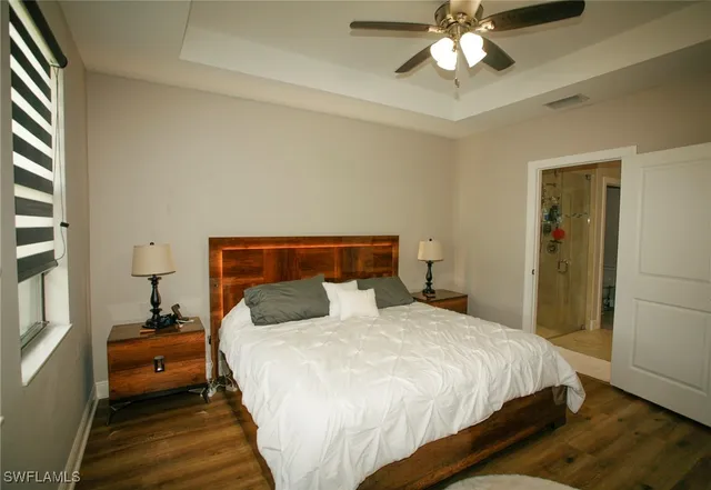 a bedroom with a bed and a chandelier