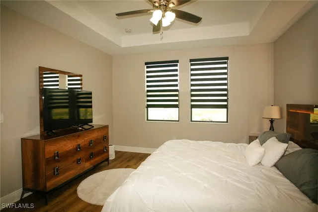 a bedroom with a bed and a television