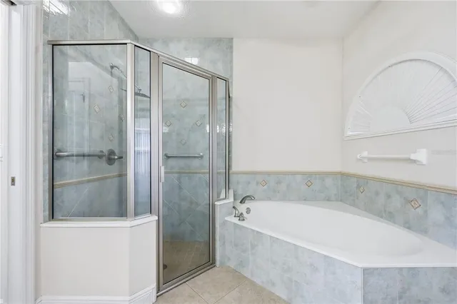 a bathroom with a bathtub and a shower