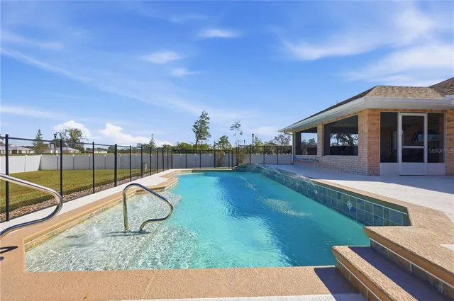 a view of a backyard with swimming pool