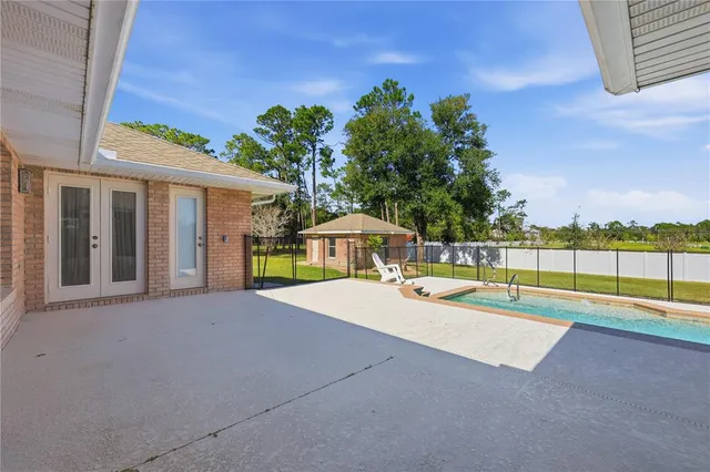 a view of a house with swimming pool and a yard