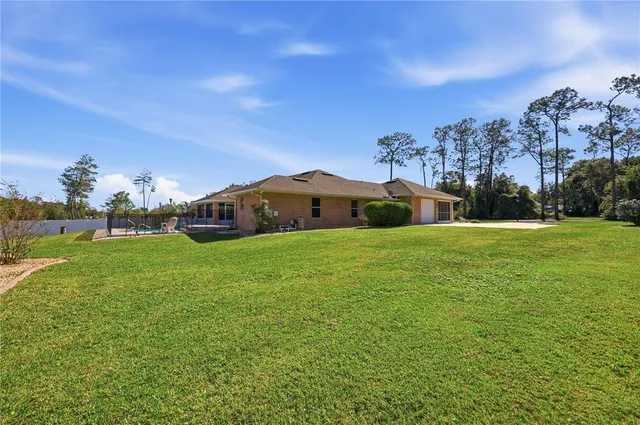 a view of green field with house in the background