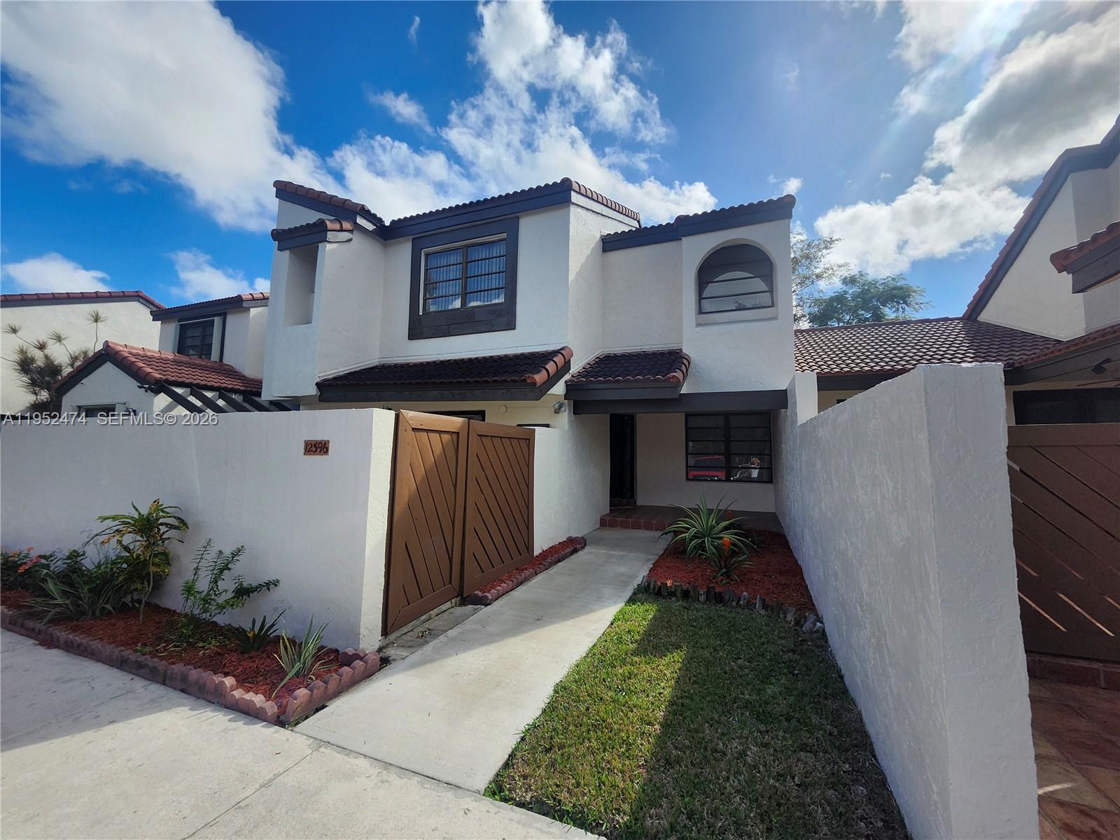 12396 Southwest 94th Lane, Unit 12396 Miami, FL 33186 - Photo 1 of 32 a view of a garage with a sink and a yard