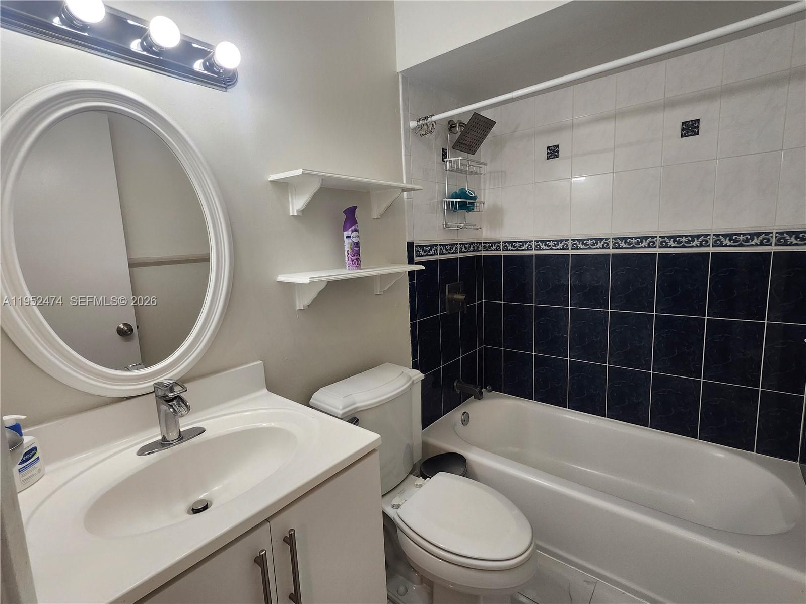 12396 Southwest 94th Lane, Unit 12396 Miami, FL 33186 - Photo 13 of 32 a bathroom with a sink a toilet and a bathtub