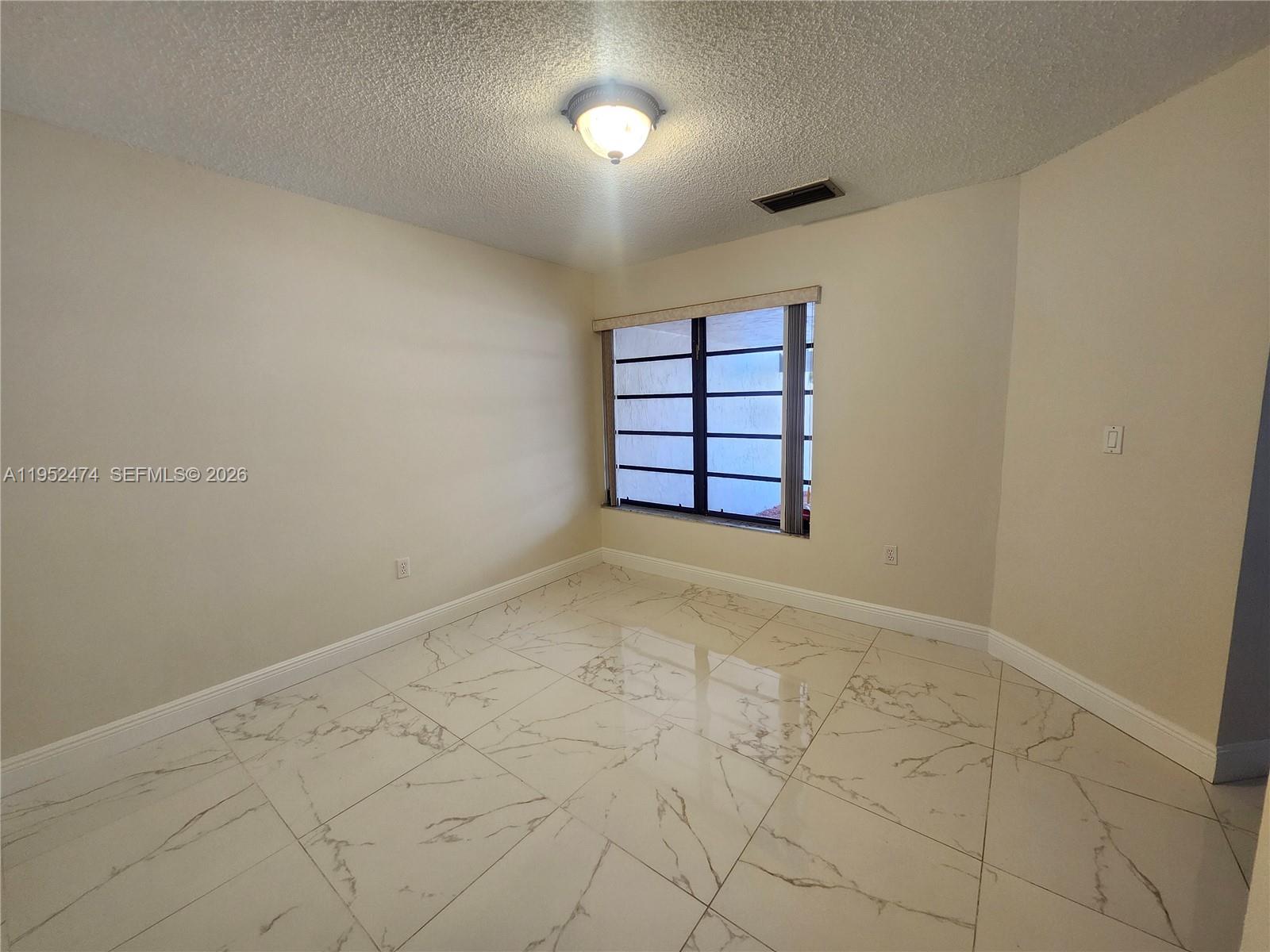 12396 Southwest 94th Lane, Unit 12396 Miami, FL 33186 - Photo 23 of 32 an empty room with windows