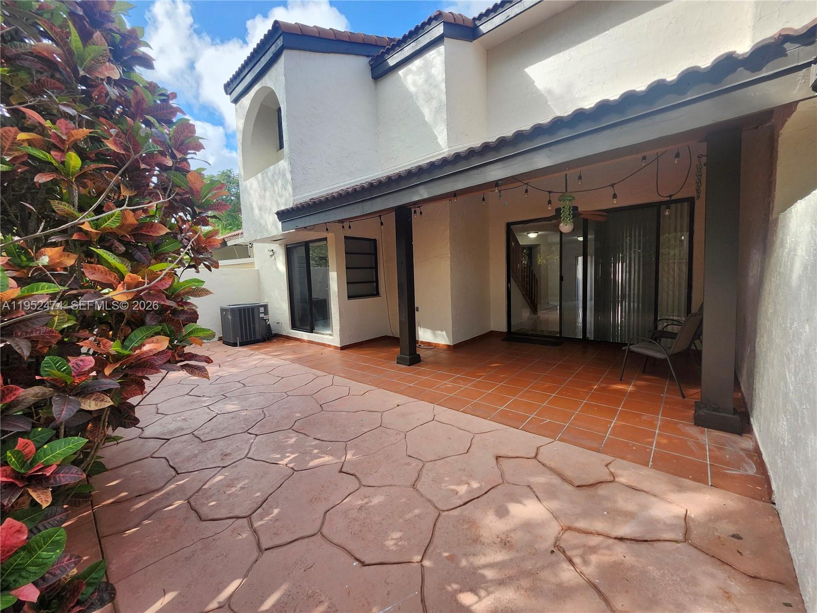 12396 Southwest 94th Lane, Unit 12396 Miami, FL 33186 - Photo 28 of 32 a view of a house with a yard