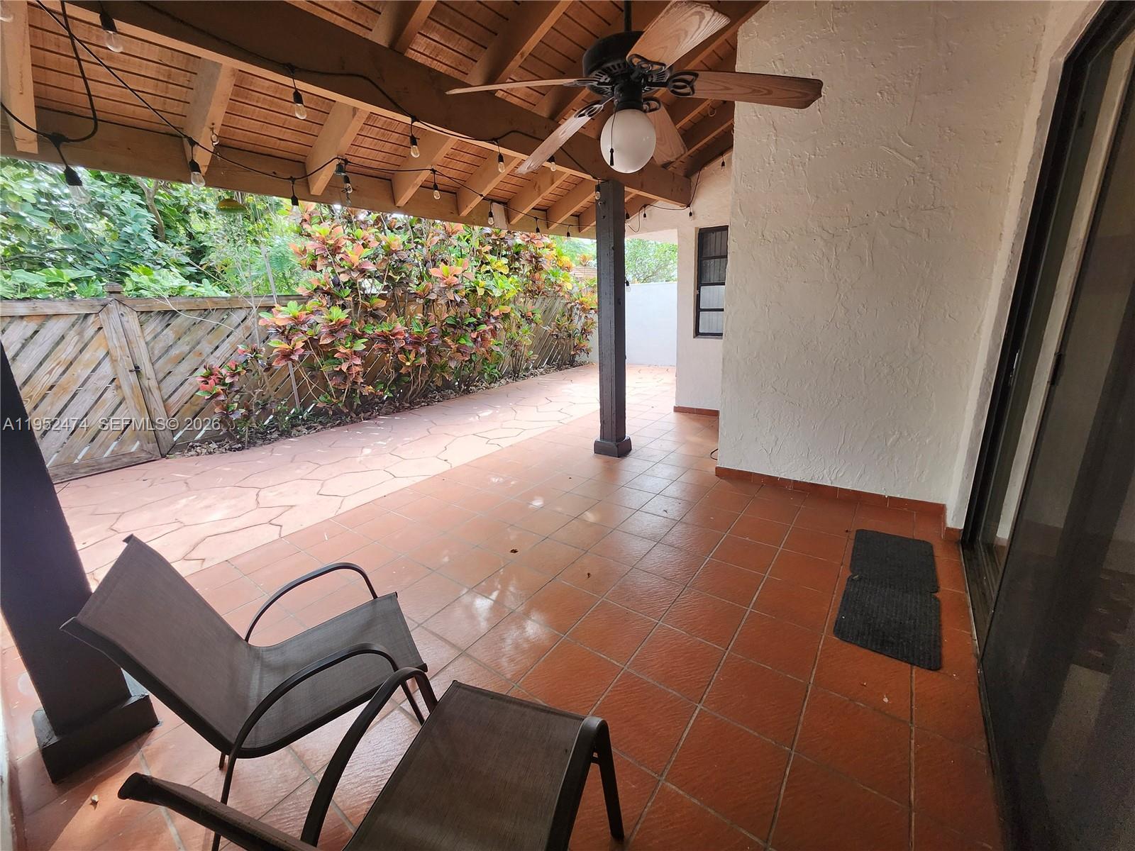 12396 Southwest 94th Lane, Unit 12396 Miami, FL 33186 - Photo 29 of 32 a view of a porch with furniture and a yard