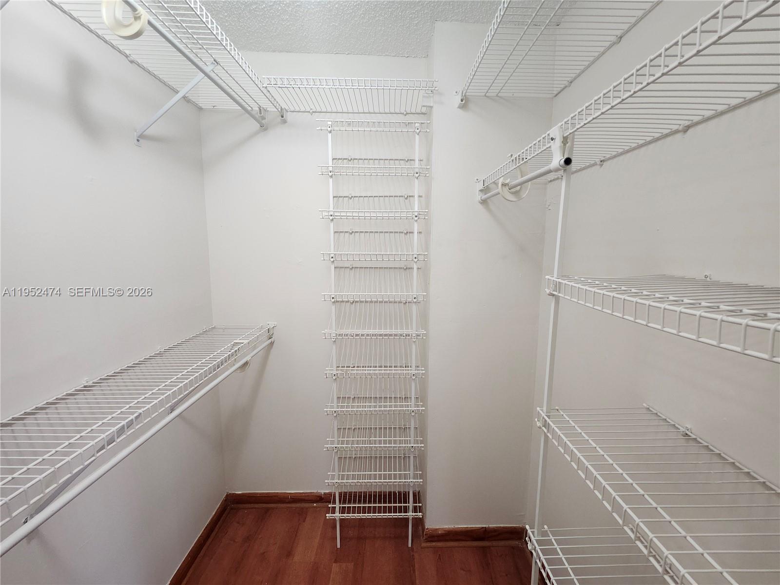 12396 Southwest 94th Lane, Unit 12396 Miami, FL 33186 - Photo 8 of 32 a view of walk in closet with empty racks