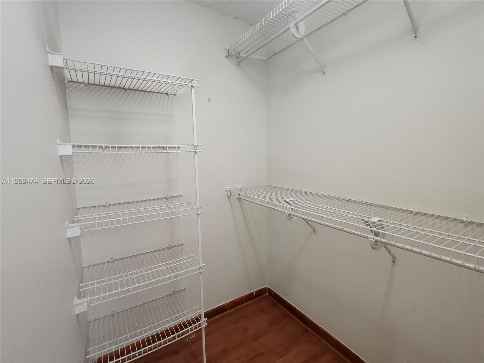 12396 Southwest 94th Lane, Unit 12396 Miami, FL 33186 - Photo 10 of 32 a view of walk in closet with empty racks