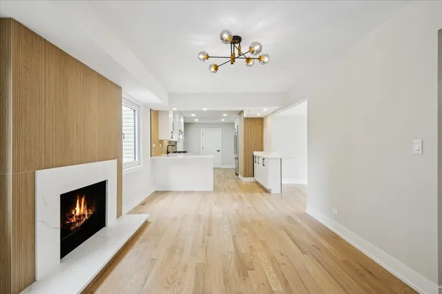 a view of a kitchen with a sink wooden floor and a fireplace