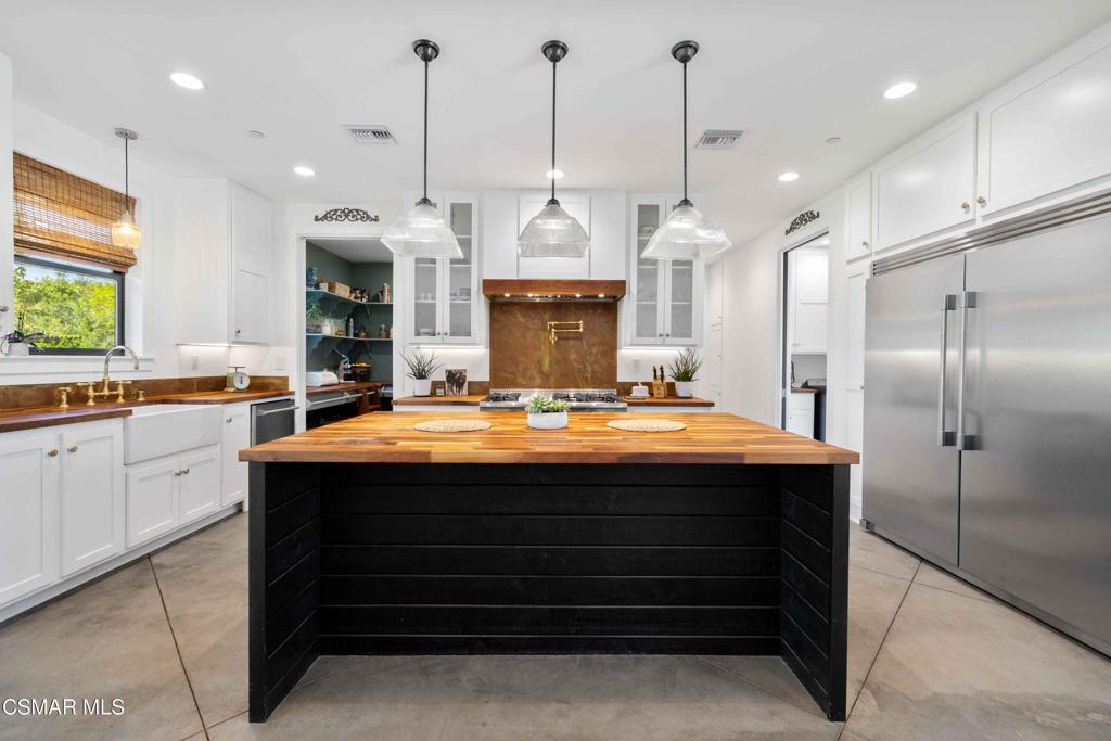 4637 Adam Road Simi Valley, CA 93063 - Photo 25 of 70 a large kitchen with kitchen island a sink stainless steel appliances and cabinets