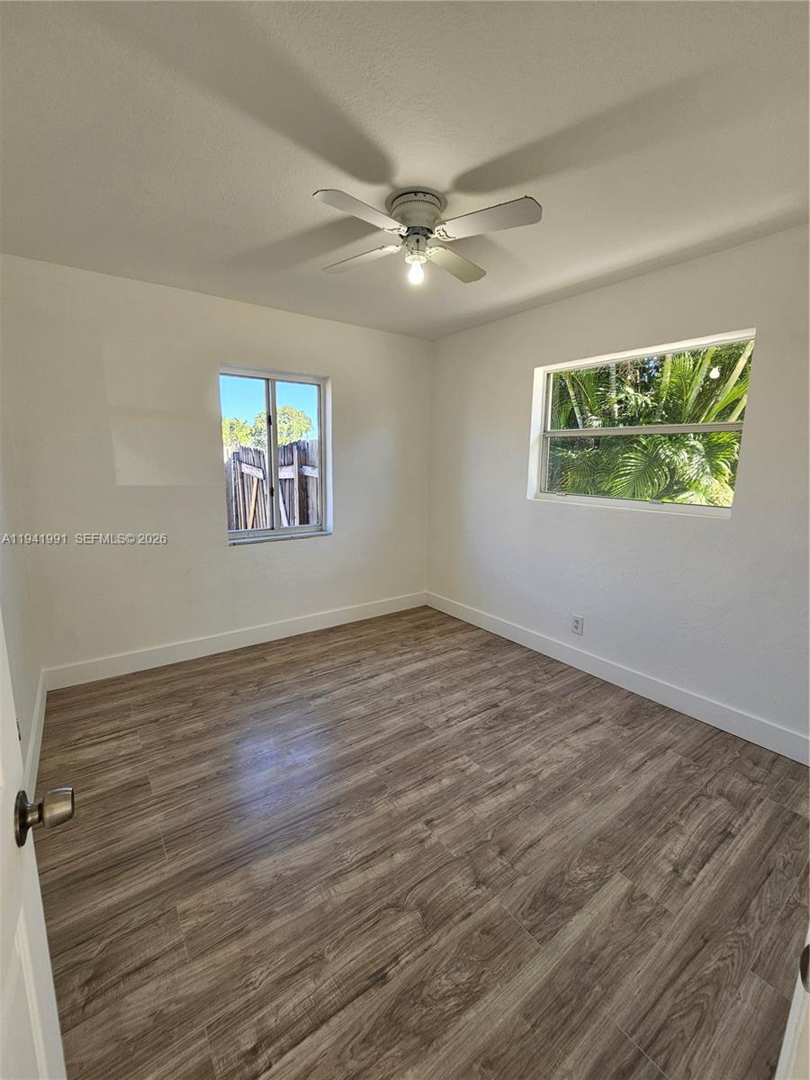 5621 Cleveland Street Hollywood, FL 33021 - Photo 11 of 19 wooden floor in an empty room with a window