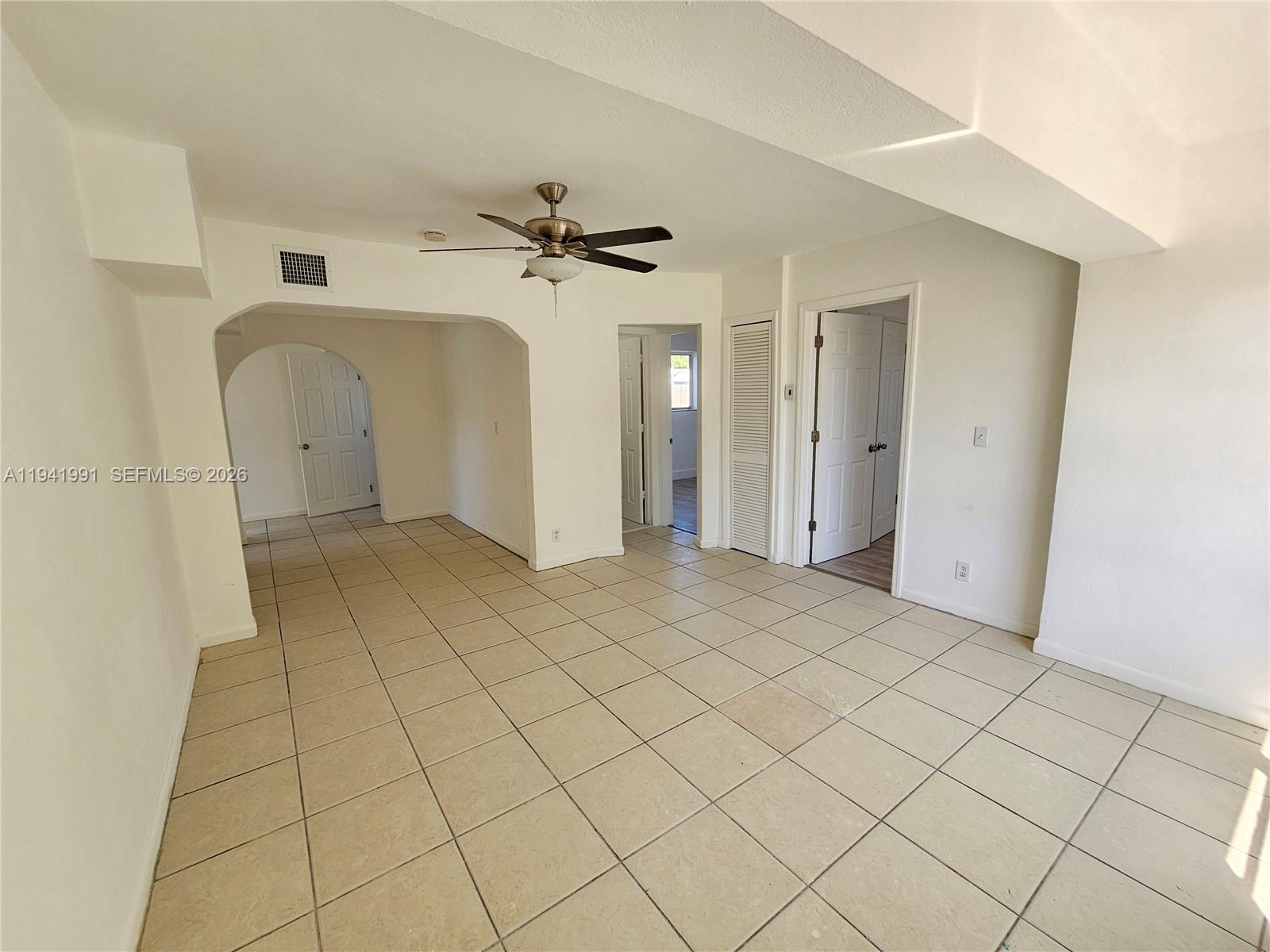 5621 Cleveland Street Hollywood, FL 33021 - Photo 12 of 19 a view of a livingroom with a chandelier fan and windows