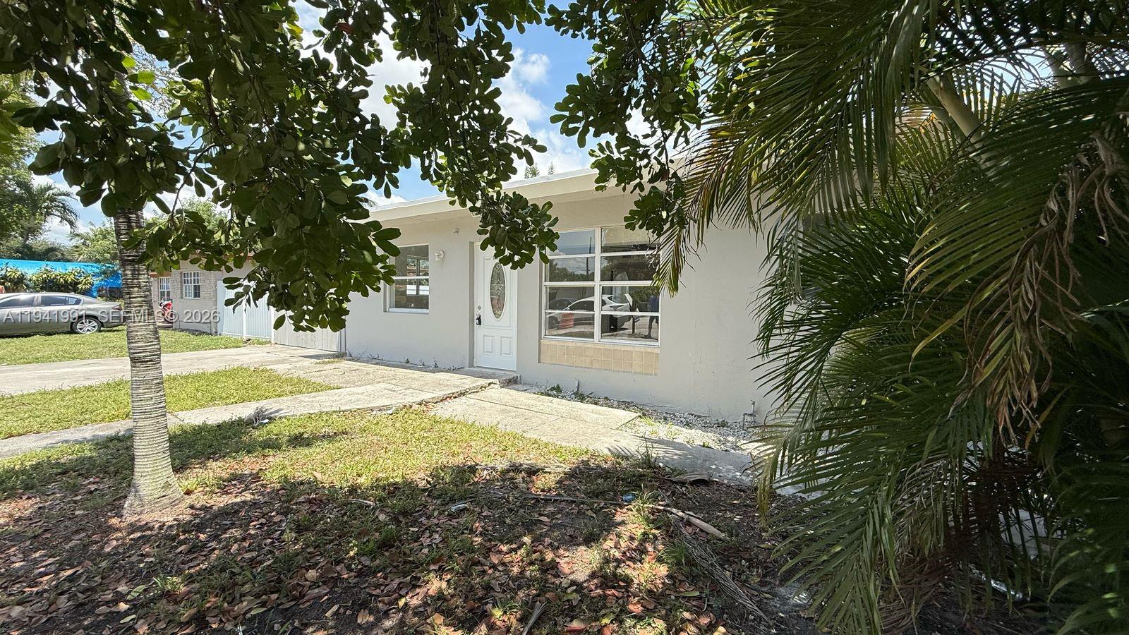 5621 Cleveland Street Hollywood, FL 33021 - Photo 15 of 19 a view of a house with backyard and tree