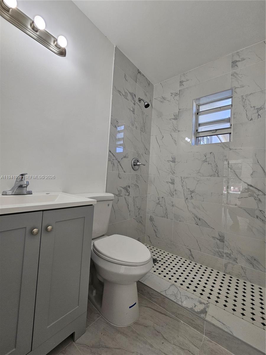 5621 Cleveland Street Hollywood, FL 33021 - Photo 2 of 19 a bathroom with a sink toilet and shower