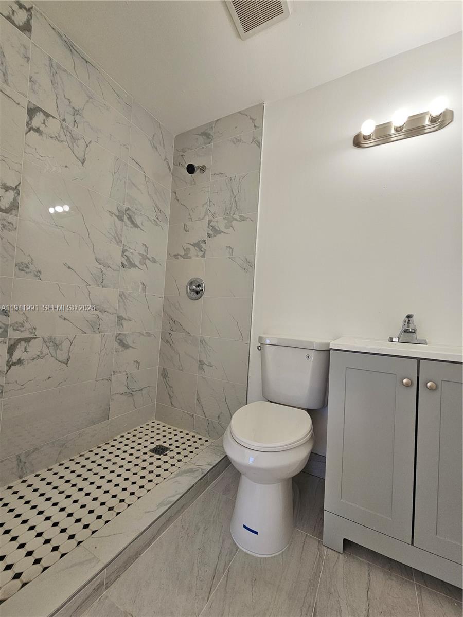 5621 Cleveland Street Hollywood, FL 33021 - Photo 6 of 19 a bathroom with a sink toilet and shower