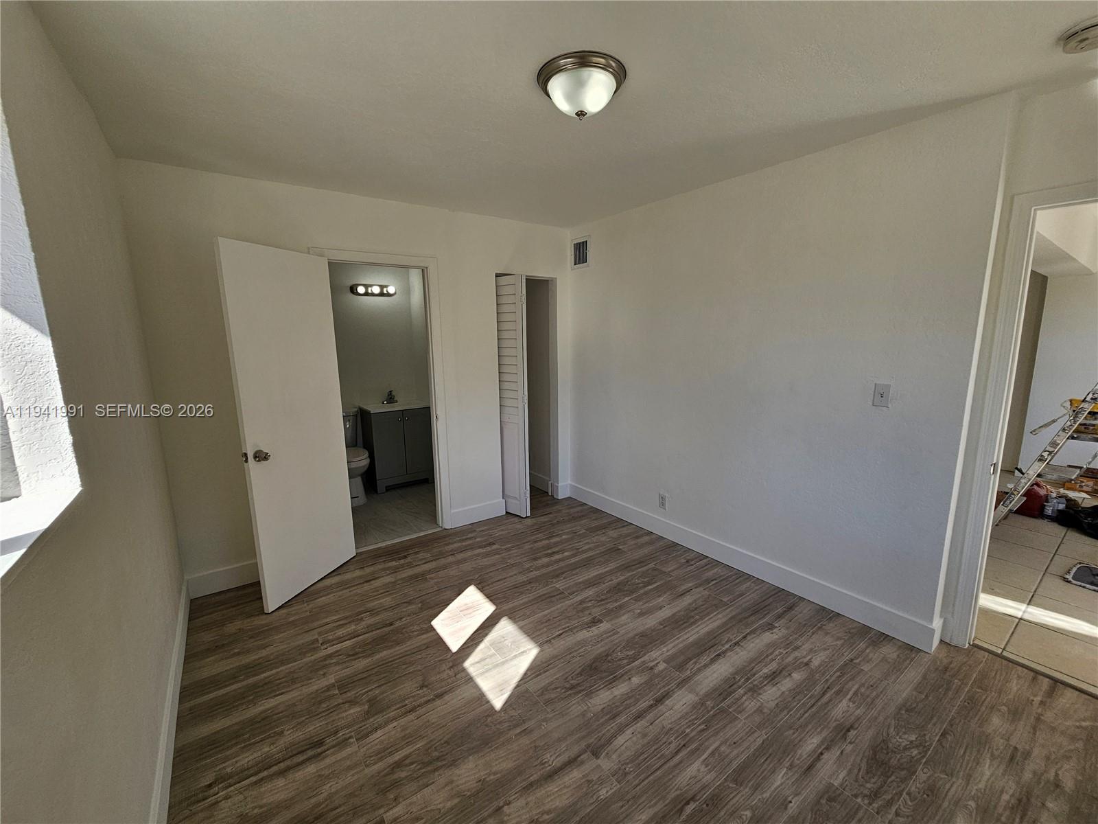 5621 Cleveland Street Hollywood, FL 33021 - Photo 9 of 19 a view of empty room with wooden floor