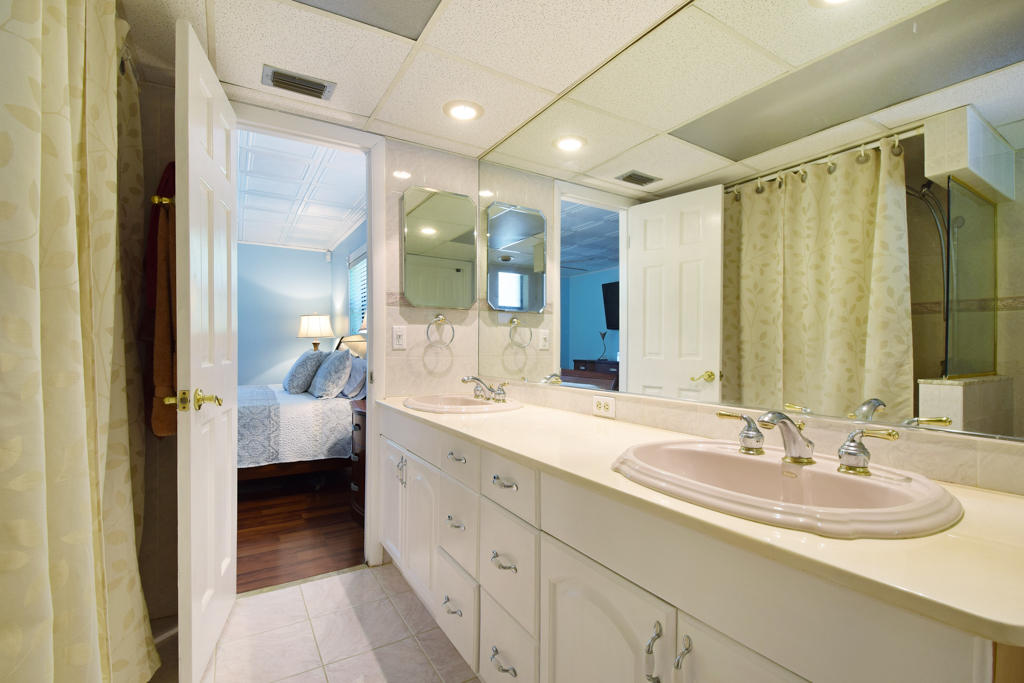 15429 Jupiter Farms Road Jupiter, FL 33478 - Photo 35 of 59 a en suite bathroom with a double vanity sink and mirror