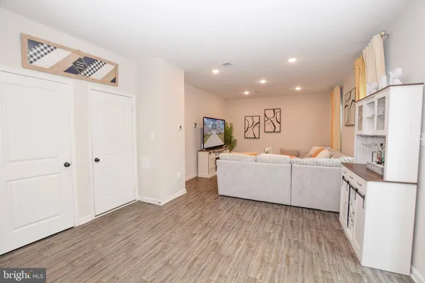 a kitchen with a sink and wooden floor
