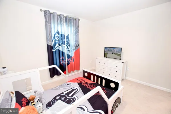 a bathroom with a double vanity sink a toilet and a tub