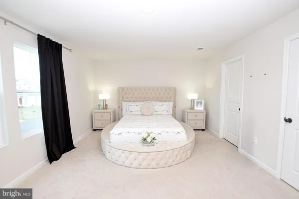 a bedroom with a bed and a cabinets