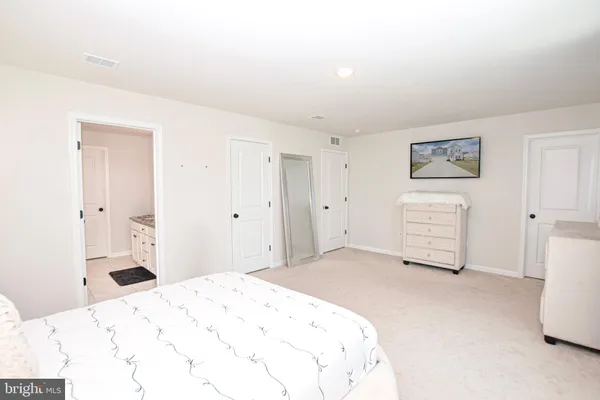 a bathroom with a granite countertop sink toilet and shower a mirror