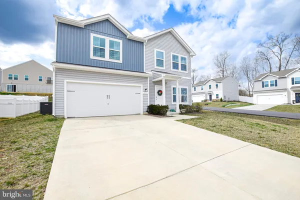a view of a house with a yard and garage