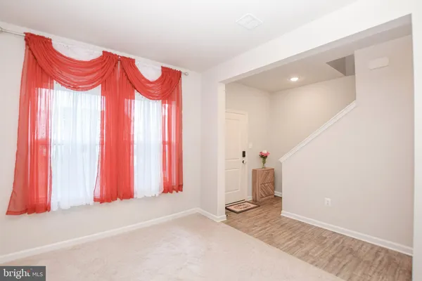 a view of a room with furniture and window