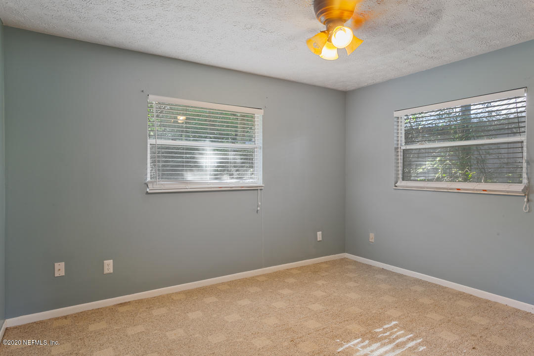 6576 Immokalee Road Keystone Heights, FL 32656 - Photo 21 of 31 a view of an empty room with a window and a fan