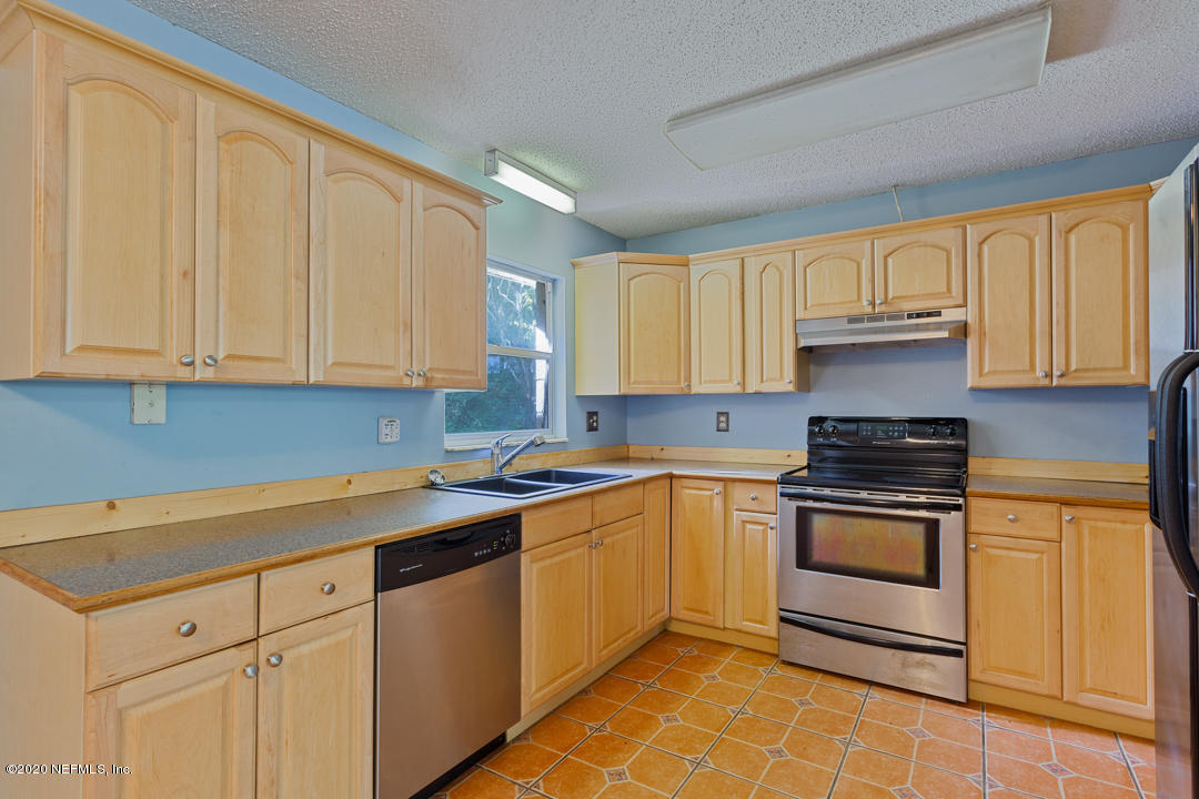 6576 Immokalee Road Keystone Heights, FL 32656 - Photo 23 of 31 a kitchen with a sink stove and cabinets