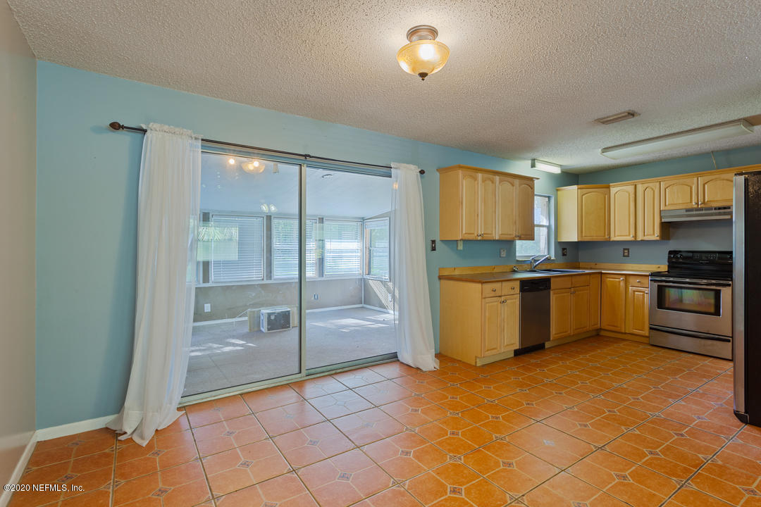 6576 Immokalee Road Keystone Heights, FL 32656 - Photo 24 of 31 a kitchen with granite countertop a stove a sink and a refrigerator
