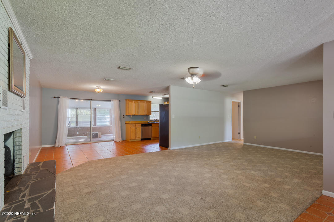 6576 Immokalee Road Keystone Heights, FL 32656 - Photo 26 of 31 a view of a livingroom with furniture a fireplace and window