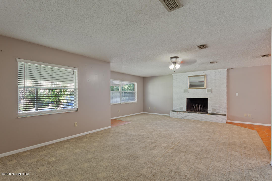6576 Immokalee Road Keystone Heights, FL 32656 - Photo 27 of 31 an empty room with windows and fireplace