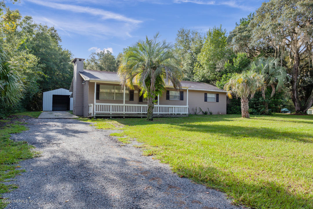6576 Immokalee Road Keystone Heights, FL 32656 - Photo 31 of 31 a house with a swimming pool in front of it
