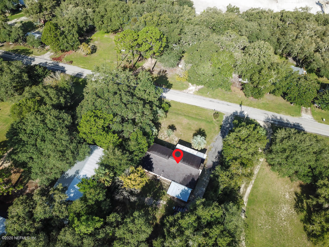 6576 Immokalee Road Keystone Heights, FL 32656 - Photo 4 of 31 an aerial view of residential house with outdoor space and trees all around