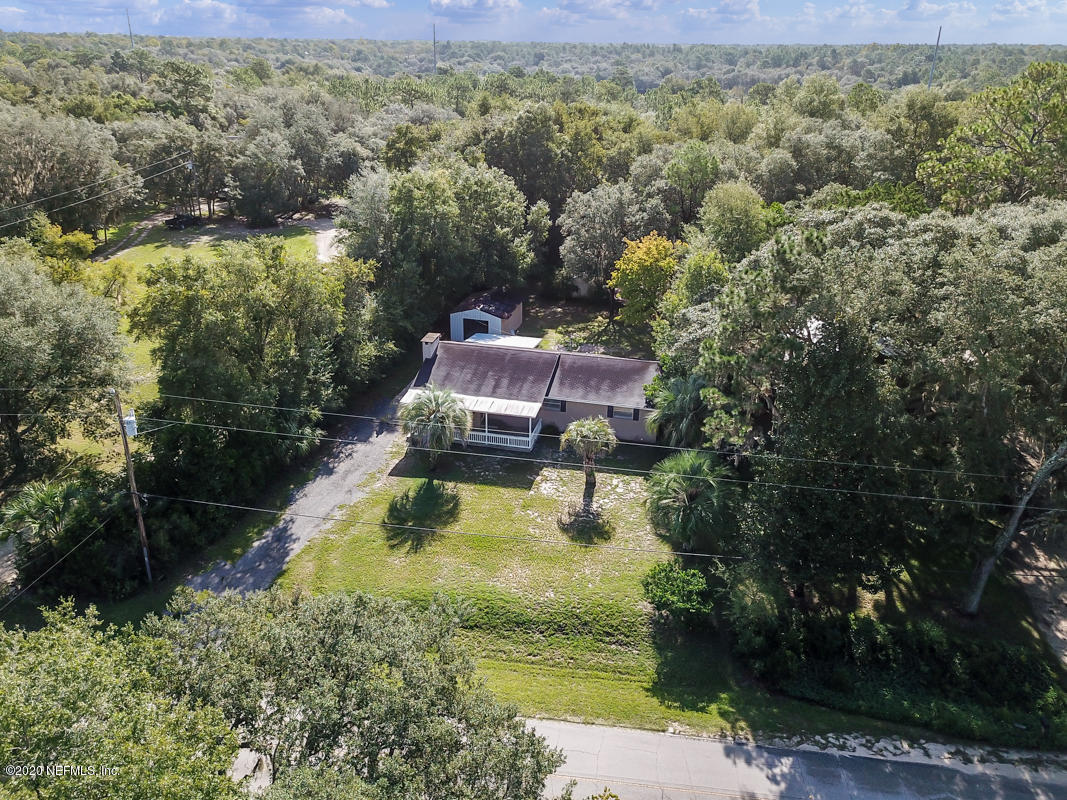6576 Immokalee Road Keystone Heights, FL 32656 - Photo 6 of 31 a view of a lake with a house in the background