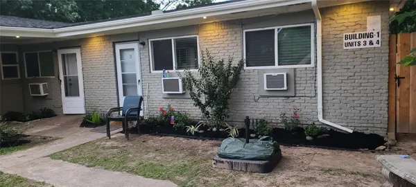 a view of a house with a yard and sitting area
