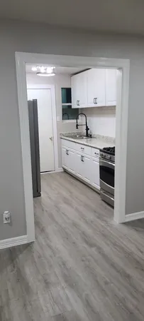 a kitchen with stainless steel appliances a stove a sink and a refrigerator
