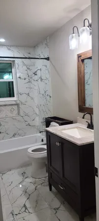a bathroom with a sink toilet and shower