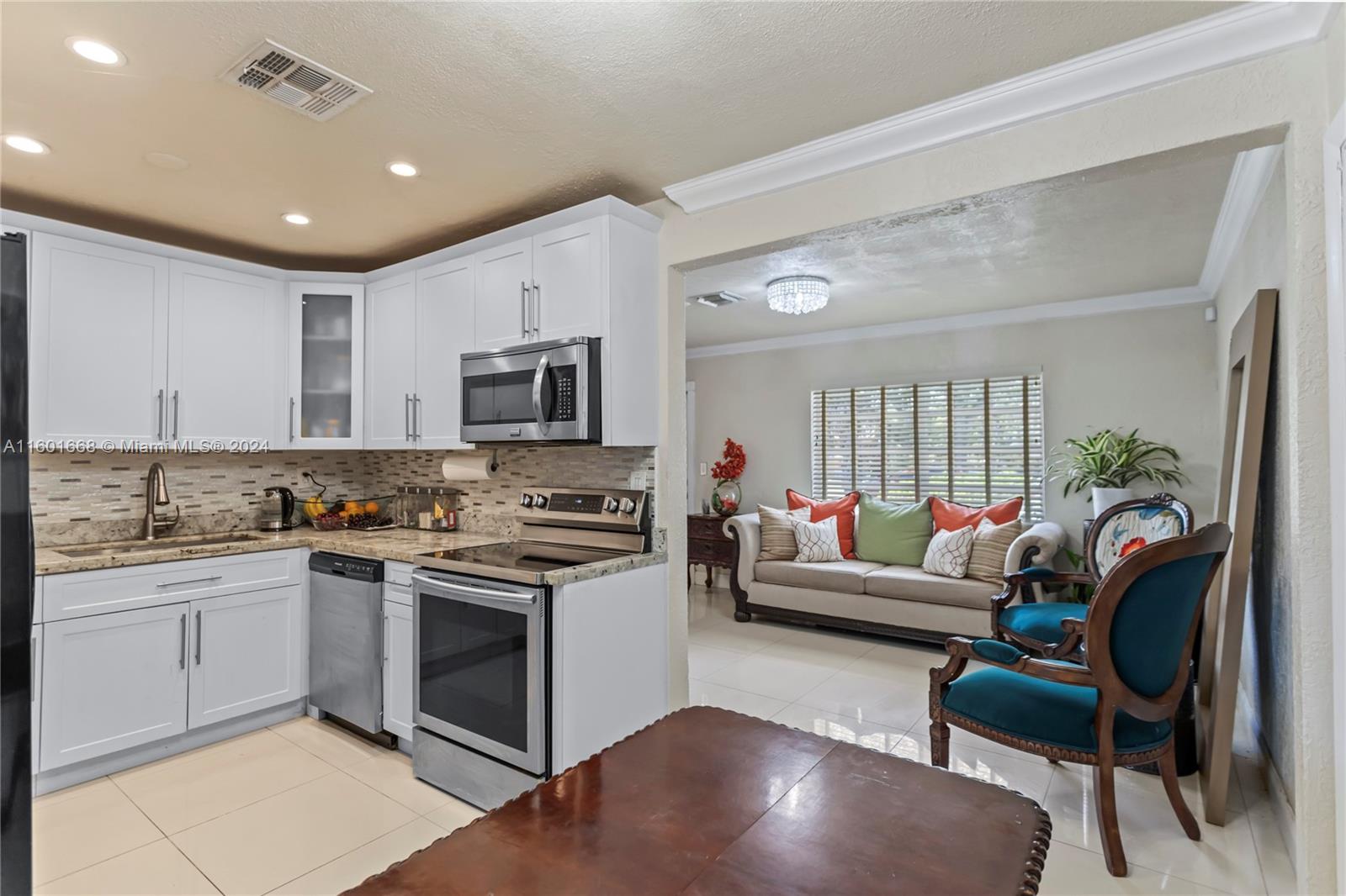 2919 Southwest 68th Avenue Miramar, FL 33023 - Photo 17 of 46 a living room with stainless steel appliances furniture a rug and a view