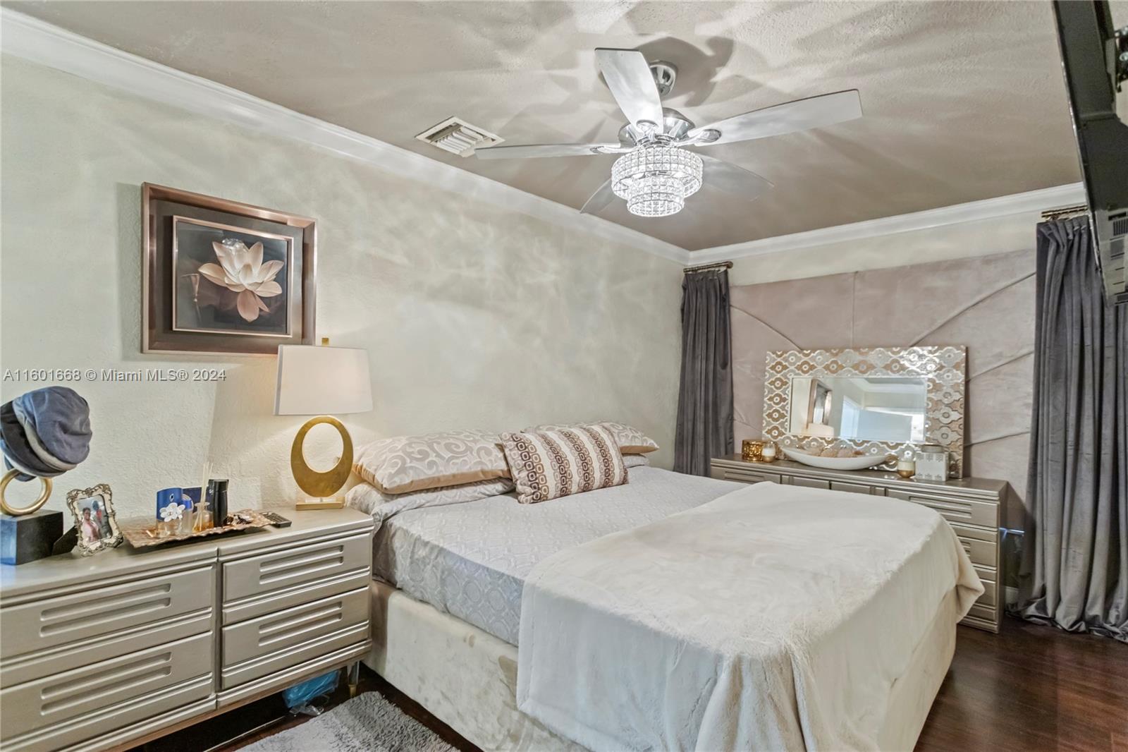 2919 Southwest 68th Avenue Miramar, FL 33023 - Photo 18 of 46 a bedroom with a bed and a chandelier