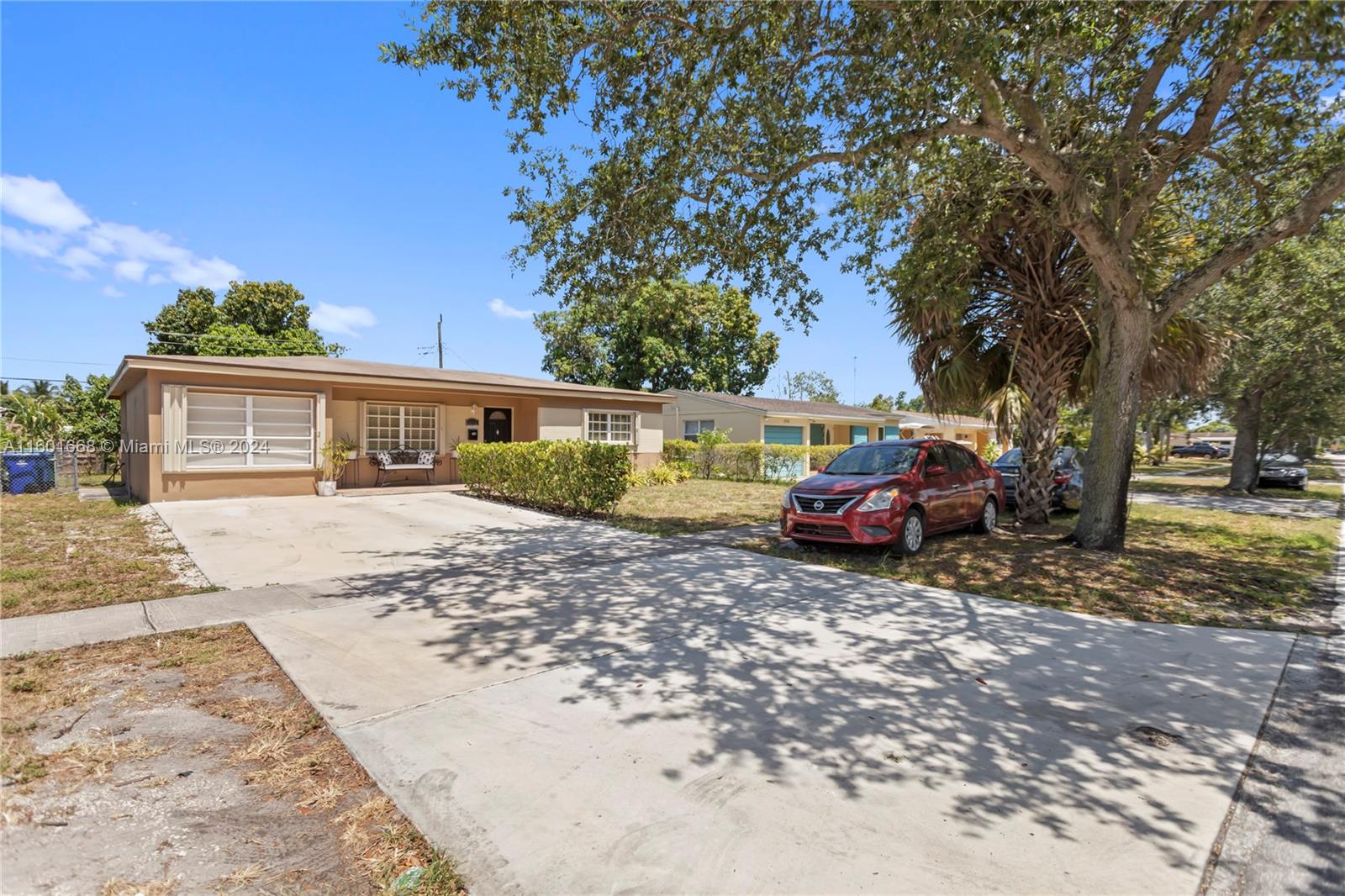 2919 Southwest 68th Avenue Miramar, FL 33023 - Photo 2 of 46 a view of a house with cars parked in front of a house