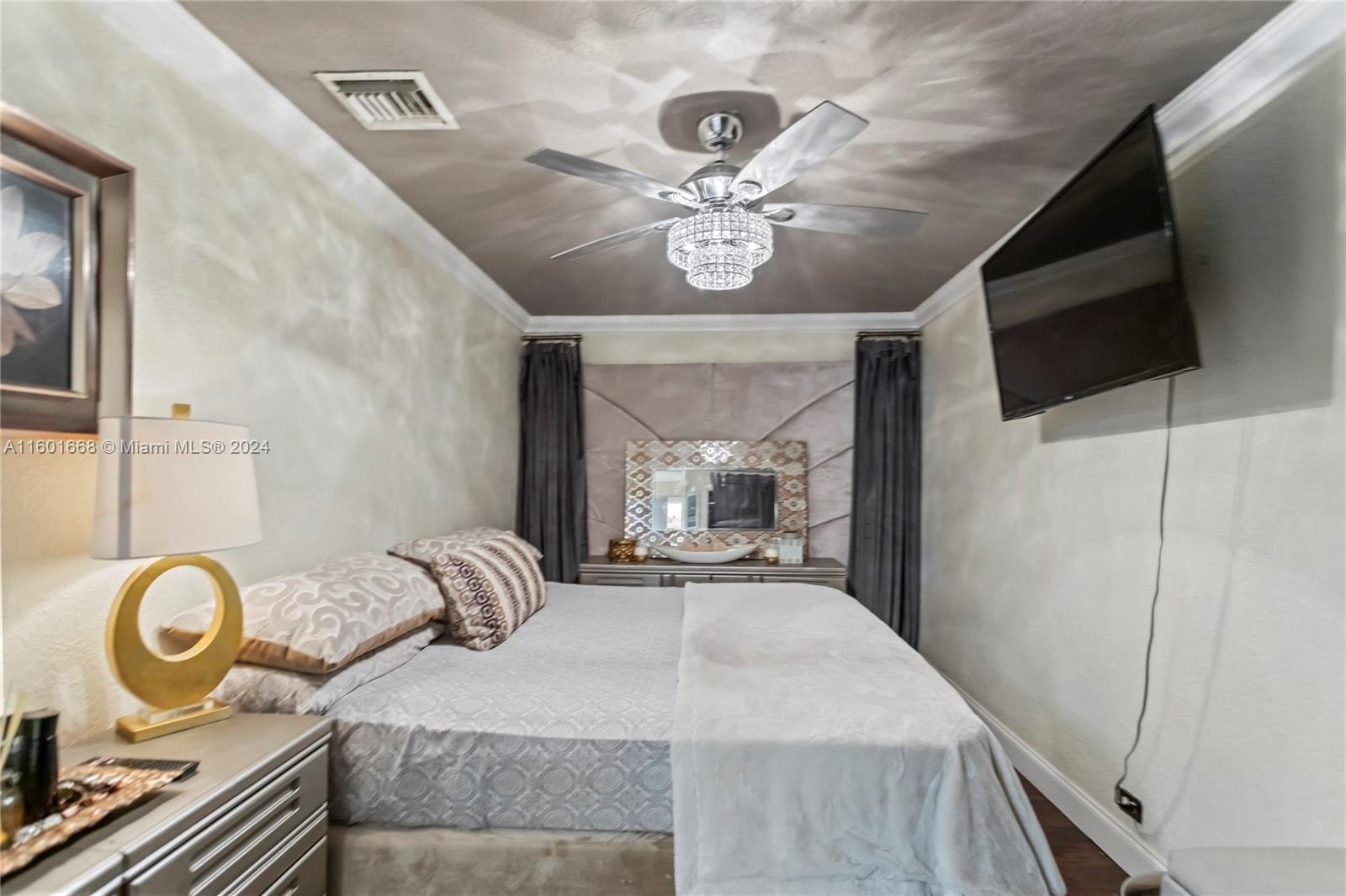 2919 Southwest 68th Avenue Miramar, FL 33023 - Photo 24 of 46 a bedroom with a bed and a flat tv screen on the dresser