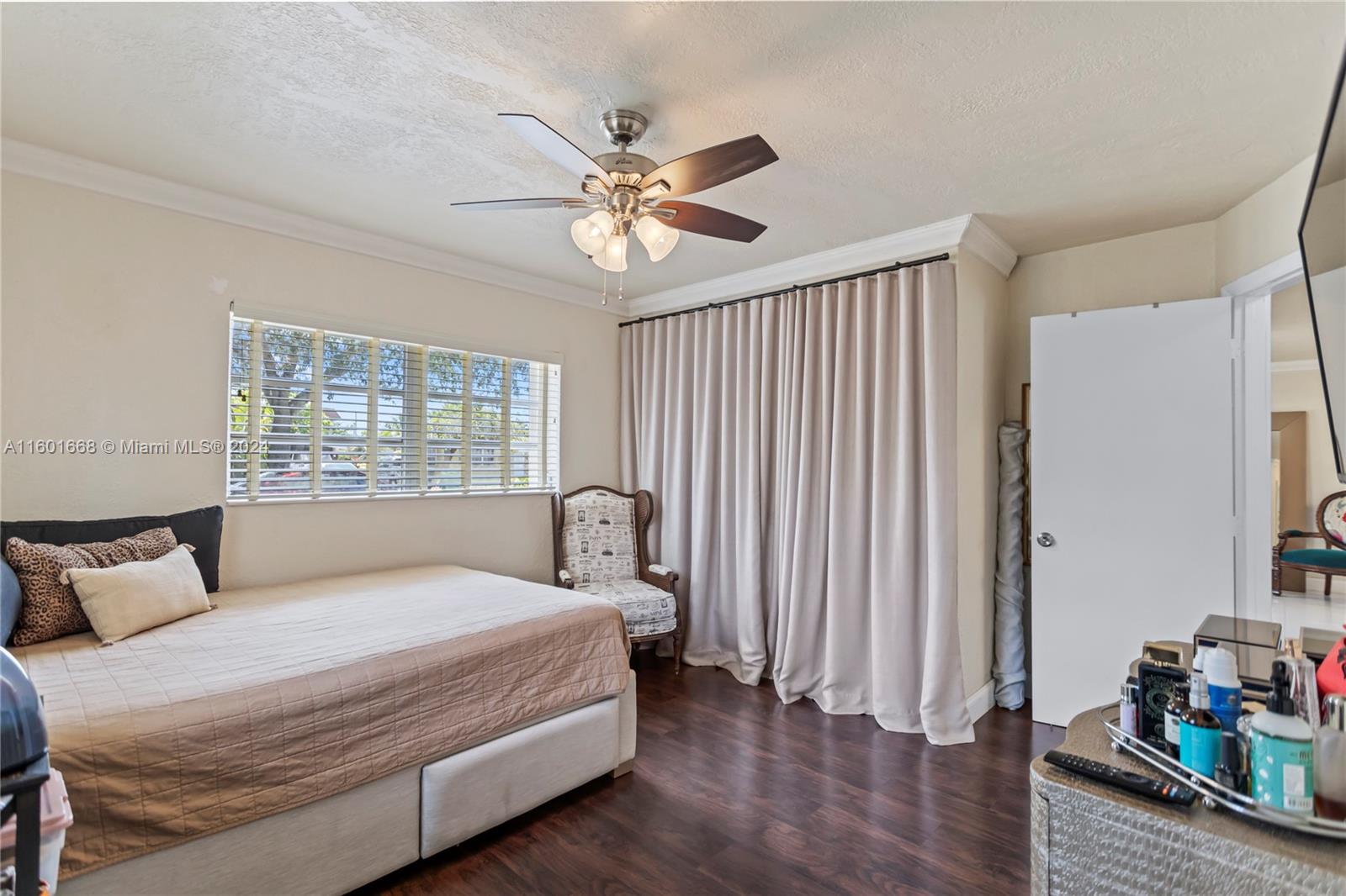 2919 Southwest 68th Avenue Miramar, FL 33023 - Photo 28 of 46 a bedroom with a large bed and a chandelier