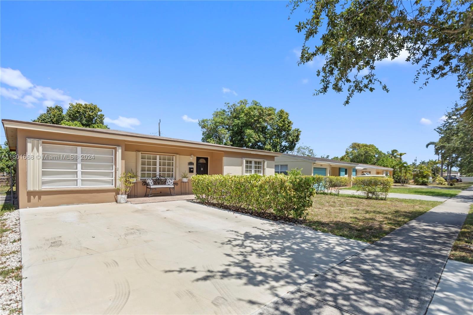 2919 Southwest 68th Avenue Miramar, FL 33023 - Photo 3 of 46 a front view of a house with a yard and garage