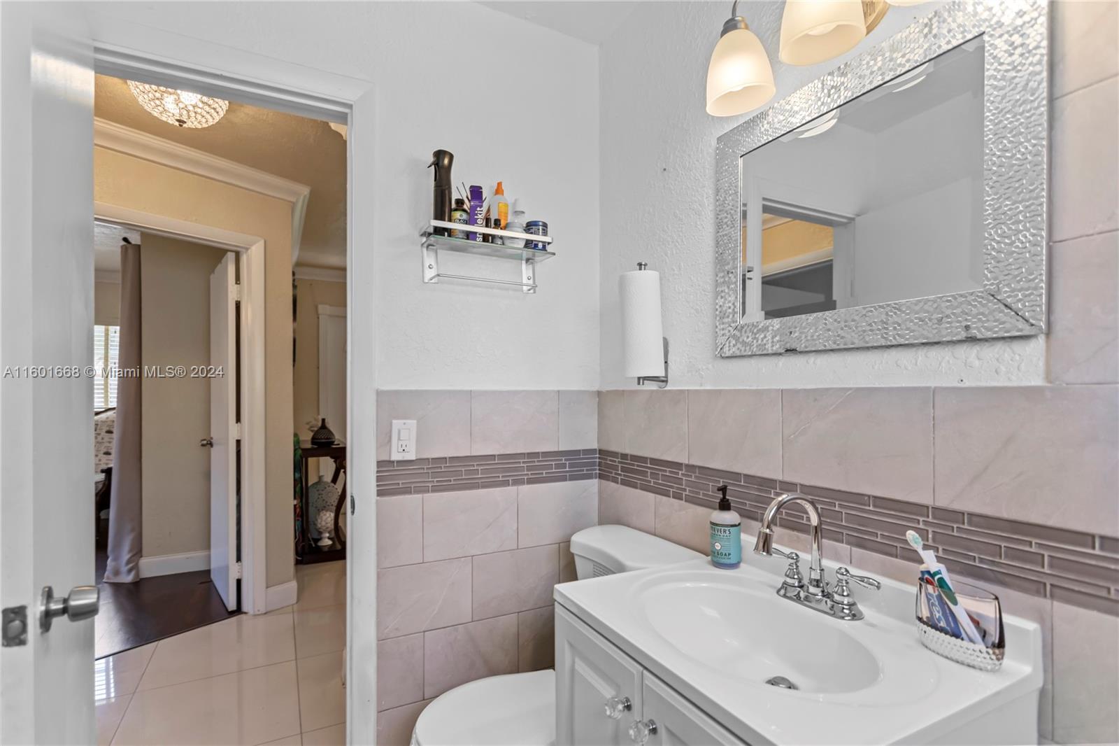 2919 Southwest 68th Avenue Miramar, FL 33023 - Photo 31 of 46 a bathroom with a toilet sink and mirror
